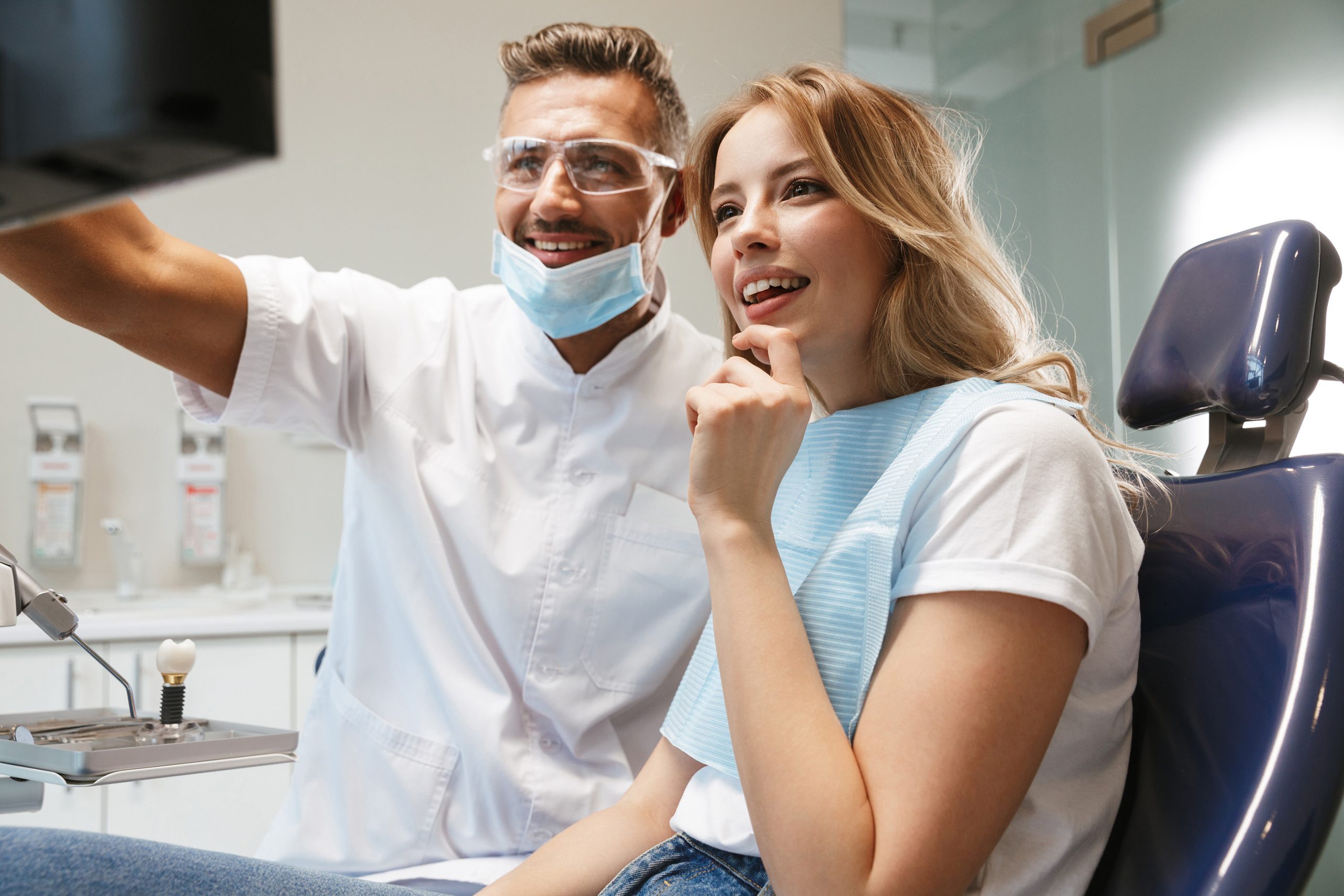 dentist and patient looking at screen - Fermelia Dental