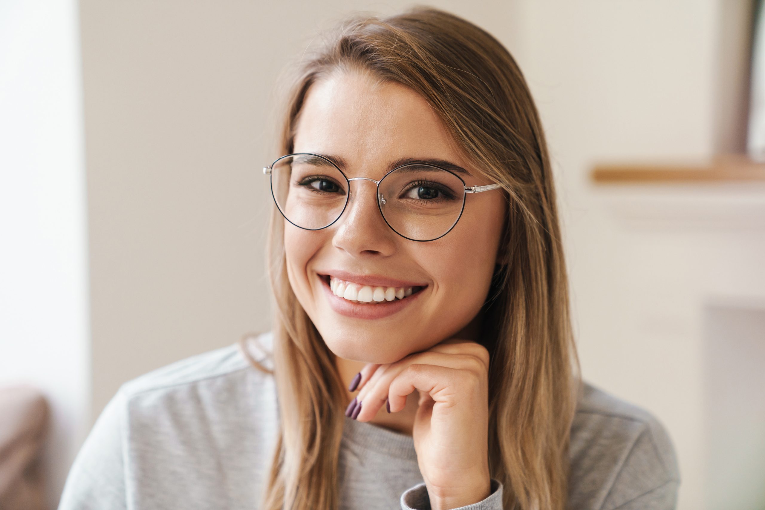 woman with glasses smiling - Fermelia Dental